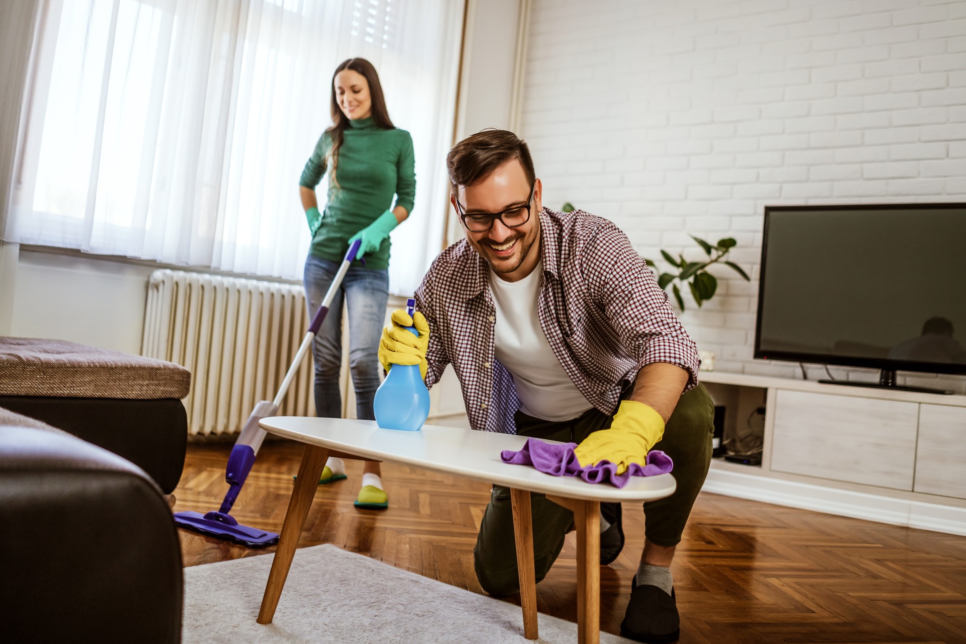 Couple cleaning at home